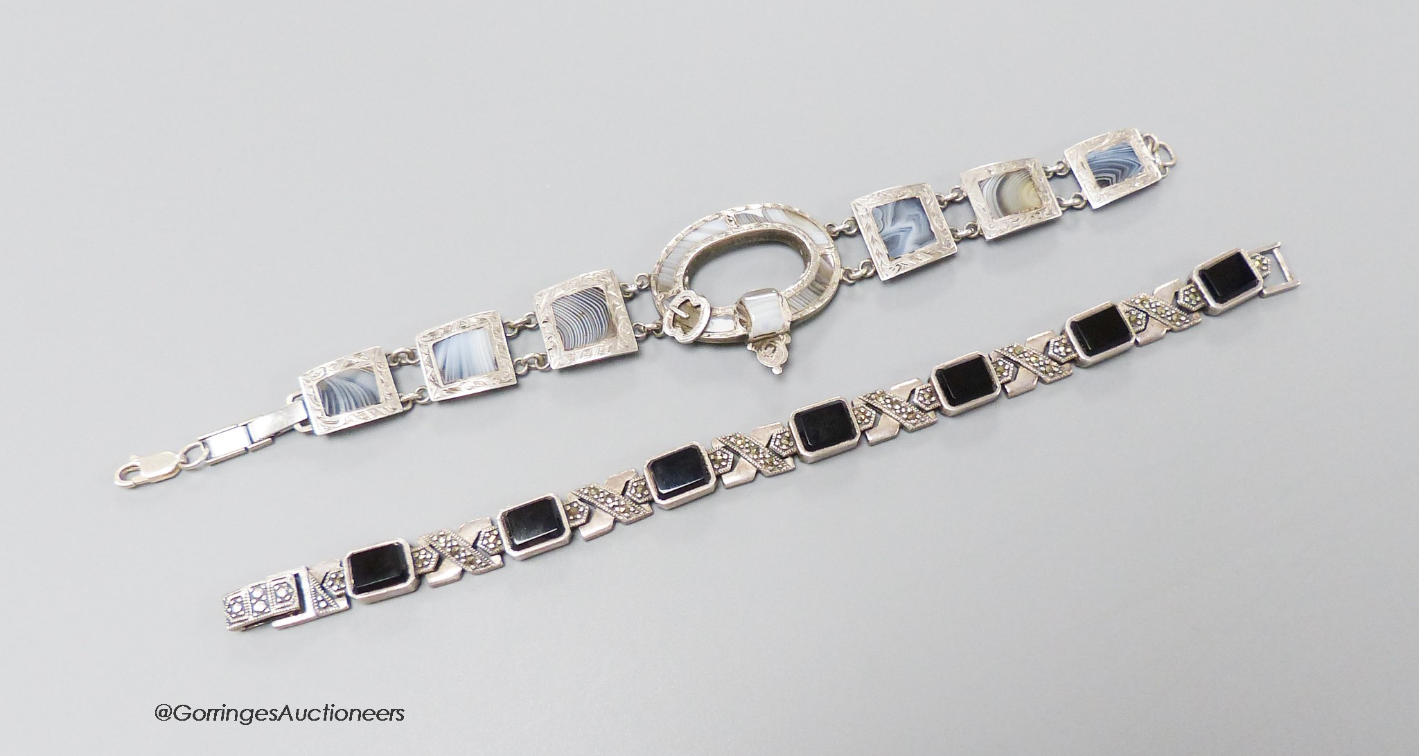 A 925 white metal and agate set bracelet, 19cm and a white metal, black onyx and marcasite set bracelet.